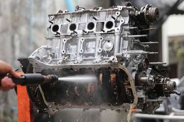 Hand cleaning car's engine