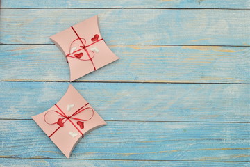 Beautiful valentines day paper hearts on blue wooden background. romantic background greeting card