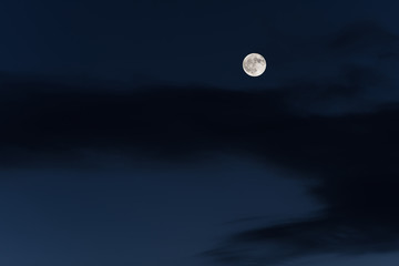 Huge full moon on the night sky.
