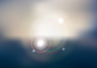 Abstract sunset or sunrise sky and sun shining blurred background with flare.