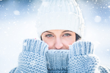 Portrait of young woman with winter clothes sweater and cap