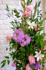 Fototapeta premium Beautiful flower bouquet in full blossom with white wall background