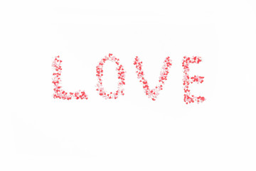 Word Love laid out of colorful hearts on a white background