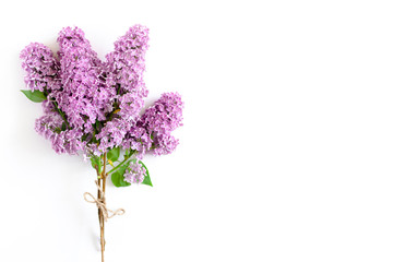 Bouquet of lilac tied with twine on a white background