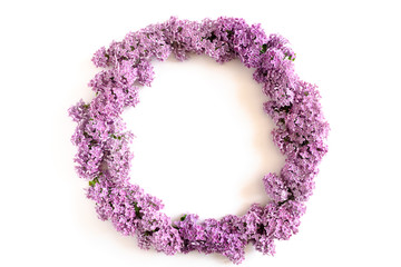 Wreath made of lilac flowers on a white background