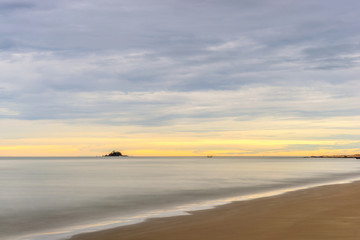 Fototapeta na wymiar Calm sea and colorful sky during sunrise. Bright seascape background.