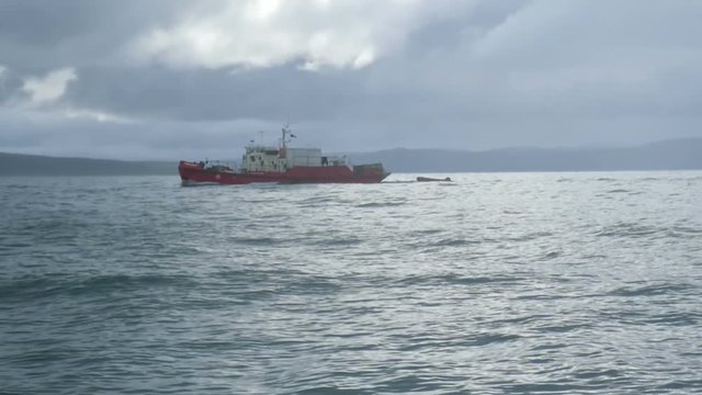 Old fishing boat at Barents sea near Russian coastline, epic shoot in stormy day