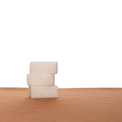 Stack of three sugar cubes on fabric, white background. Healthy eating.