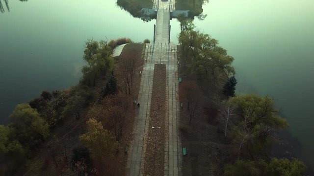 Aerial footage over Echo Park Lake, Kishinev, Moldova republic of. View of lake and smille bridge.