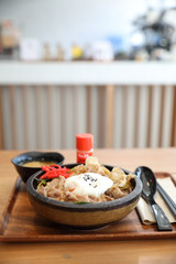 Japanese food Gyudon Japanese beef on rice bowl topped with egg on wooden table