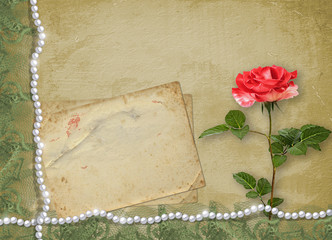 Holiday card with pearls and bouquet of beautiful red roses on green paper background
