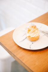 Obraz na płótnie Canvas choux cream on wooden table