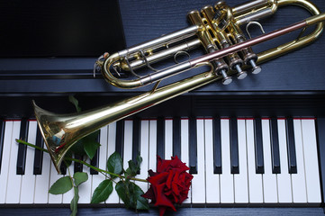 Piano keyboard, trumpet and red rose. Close-up © yrafoto