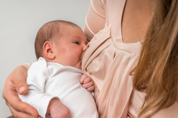 Mother is breastfeeding her newborn baby