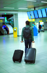 The man at the airport with a suitcase