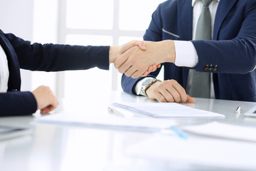 Group of business people or lawyers shaking hands finishing up a meeting , close-up. Success at negotiation and handshake concepts