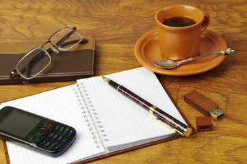 Cup of coffee, fountain pen, flashcard, notebook and glasses