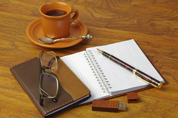 Cup of coffee, fountain pen, flashcard, notebook and glasses
