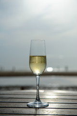 champagne glass with blurred sea and sky background