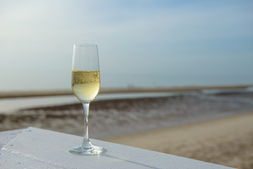 champagne glass with blurred sea and sky background