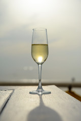 champagne glass with blurred sea and sky background