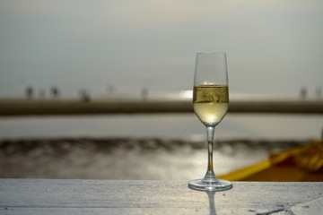 champagne glass with blurred sea and sky background