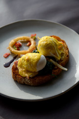 Poached egg with hollandaise sauce on toast with salmon ham and spinach
