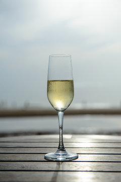 champagne glass with blurred sea and sky background