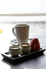 Hot tea served in a mug with milk and sugar