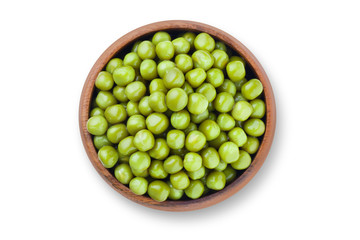 Green peas in a wooden bowl, isolated on white background, view from above