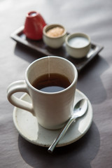 Hot tea served in a mug with milk and sugar