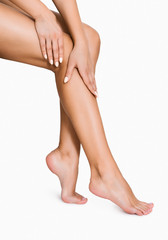Woman applying moisturizer on her perfect legs