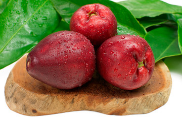 Exotic fruit Syzygium malaccense with leaves wood background