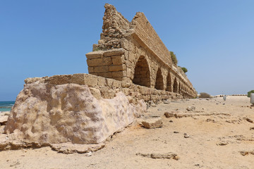Caesarea Aqueduct Roman ruins on beach