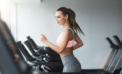 Sports woman doing cardio training on treadmill