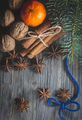 Bunch of cinnamon orange anise next to pine branch