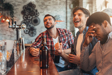 Men watching football match in sport bar