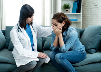 Woman patient receiving bad news. Friendly Doctor comforting and support sad patient with empathy