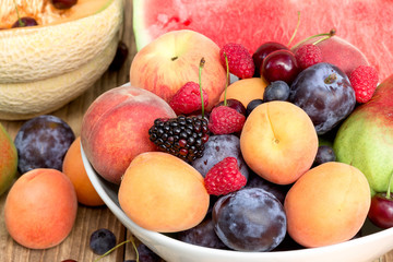 Healthy food, vegetarian diet - fresh organic fruit in bowl on table