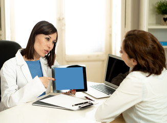 Smiling woman Doctor specialist having consultation using digital tablet to inform patient