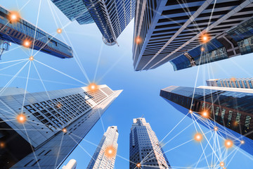 Digital network connection lines of architectures, skyscraper buildings in Singapore City with blue...