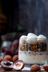 Healthy breakfast. Granola, lychee and yogurt in a glass. Parfait