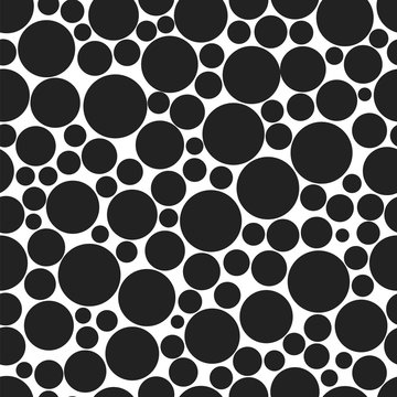 Black circles of various sizes on a white background. Seamless vector pattern.
