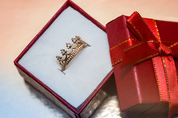 Red gift box with golden ring like crown