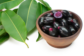 Exotic fruit Syzygium cumini called in Brazil as jamelão in wood bowl background with one cut