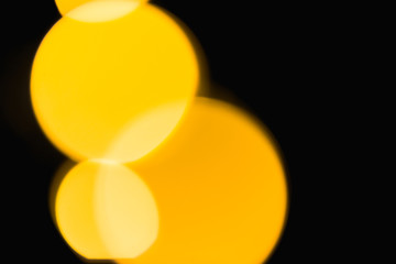 Defocused Yellow Bokeh Rings on a Black Background
