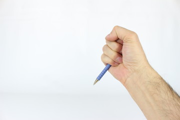 The right hand, of a man, holds a common object, a pen. sphere.