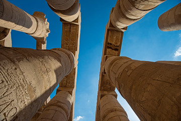 Ancient egyptian hieroglyphic carvings on columns in temple
