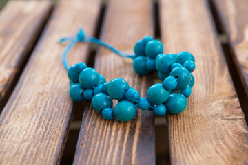 Blue beads handmade. Wooden background. Handmade wood 