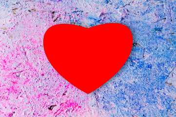 red heart on color textured background